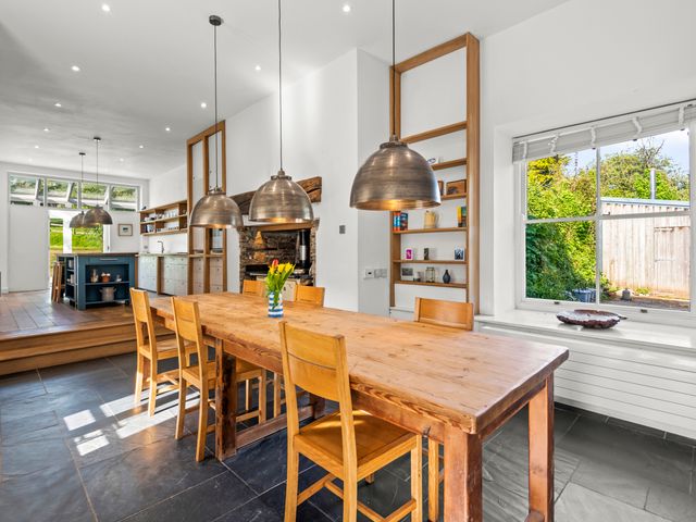 A kitchen with a dining table and chairs at Chantry Studio in Kingsbridge