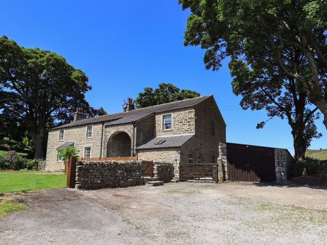 A house with trees and a gravel driveway at Ragged Hall Barn Settle
