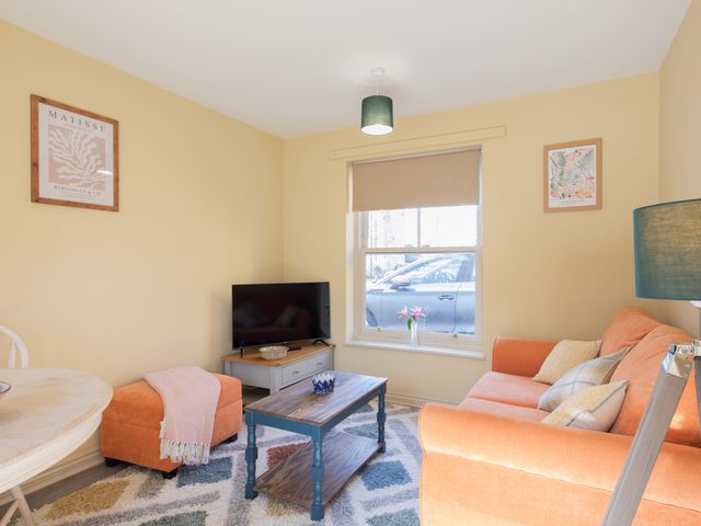 A living room with a sofa and TV at Sheriff's Tower Cottage - East, Bishop Auckland