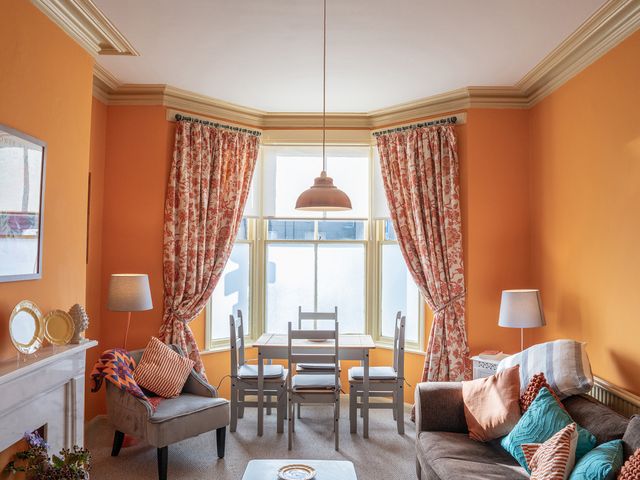 A living room with a table and chairs next to a sofa at No 4 Townhouse in Bishop Auckland