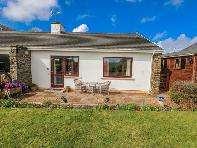 A garden area with seating and flowers at Harvest Hill in Letterston