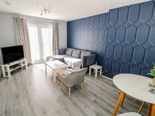A living room with a sofa and television at 32A Cramp Hill- 1 bed Darlaston