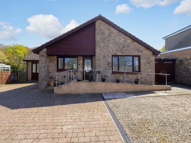 A house with a driveway and steps at Willow cottage in Seahouses