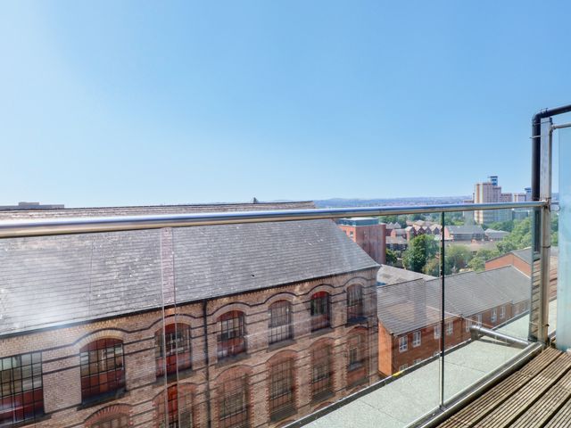A balcony with a view of rooftops and buildings at Apartment 610 in Nottingham