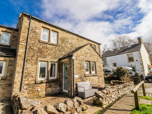 A stone house with windows and a front door at 2 Rock View in Settle