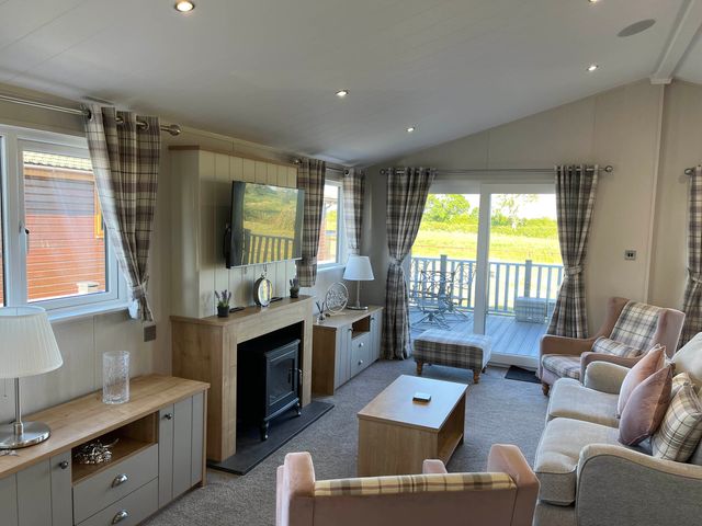 A living room with a television and seating area at Yorkshire View Lodge in Wilberfoss