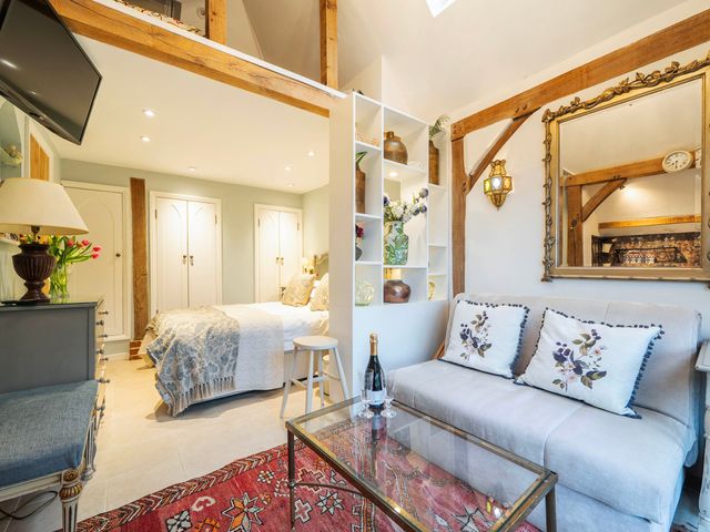 A studio with a sofa and coffee table at Bramble Bank 'CartShed'-1 Bed Cottage-Sleeps 2 Henley-On-Thames