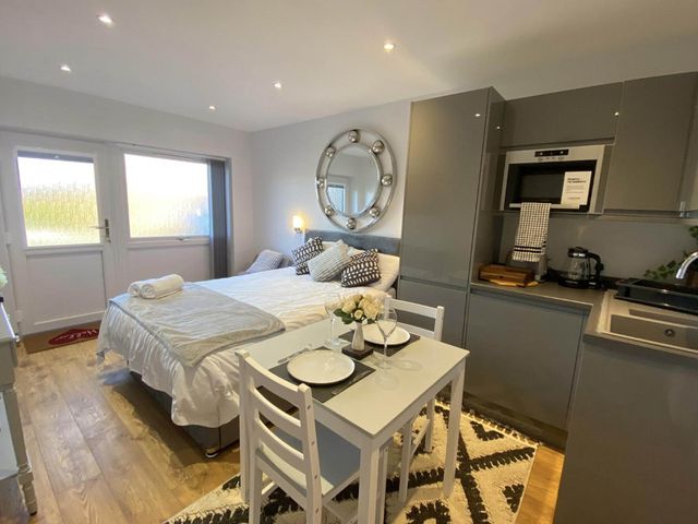 A studio with a bed and dining table at Beautiful 1-Bed studio in Penrith