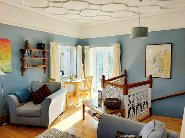 A living room with a sofa and dining table at 1 Bed Lodge - Sleeps 2 - Parking - Wifi in Salen