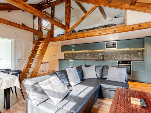 A living room with a sofa and dining area at Sedbergh Penthouse - KingBed - Tv - Wifi, Sedbergh