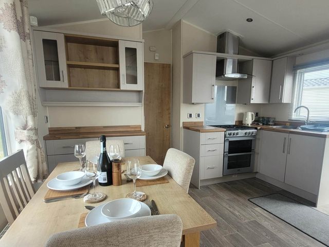 A kitchen with a dining table set at Beachside Lodge - Sleeps 6 - Pets ok - Parking, Heysham