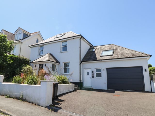 A house with a garage and front garden at Lorrell Salcombe