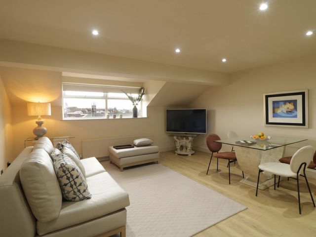 A living room with sofa and television at Apartment 2 in Derry