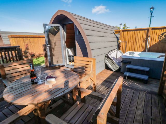 An outdoor area with a hot tub and seating at Sage Sanctuary in Whitby