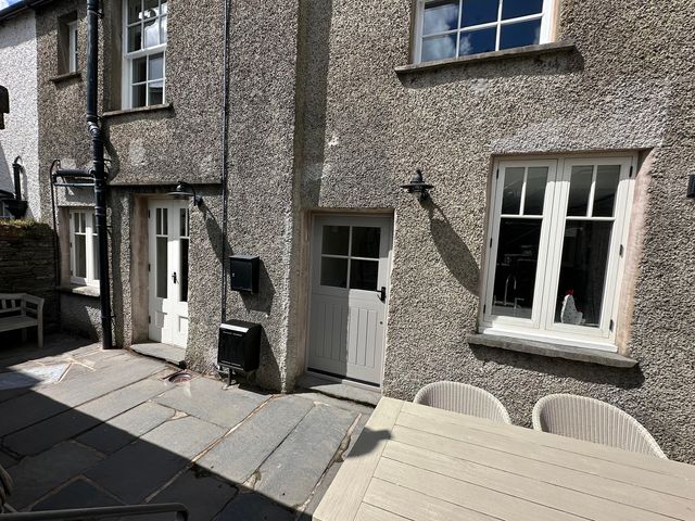 An outdoor area with a table and chairs at La'al Kirkstone Brow in Ambleside
