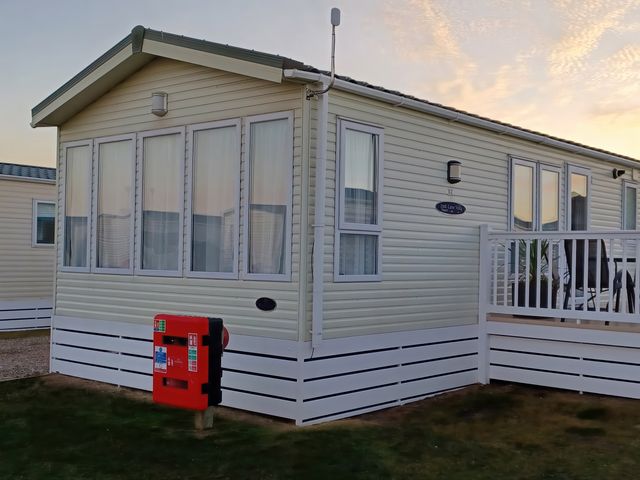 A caravan with windows and balcony at Park Lane View in Lossiemouth