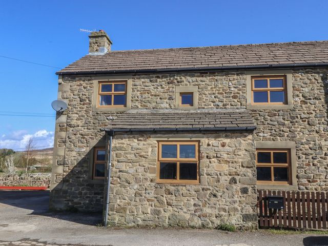 A stone cottage exterior with windows and a roof at 1 Upper Austby Farm Cottage Ilkley