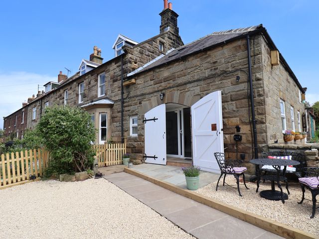 An outdoor area with seating and a garden at Little Holm Garth in Whitby