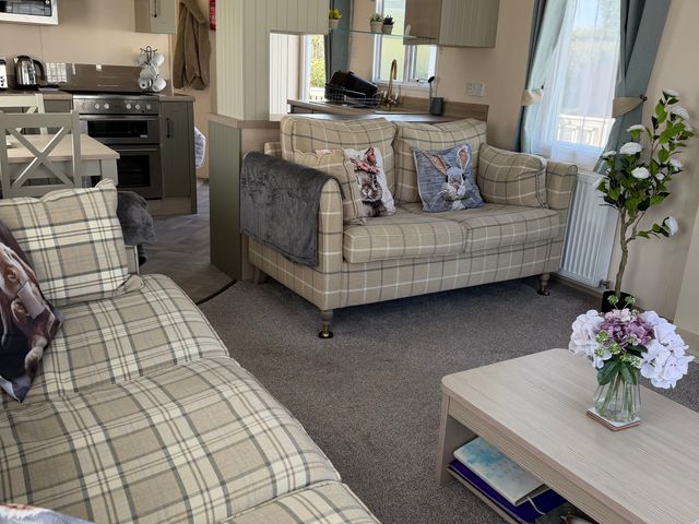 A living room with a couch and coffee table at Hoburne Blue Anchor - Holiday Accommodation 307 Minehead