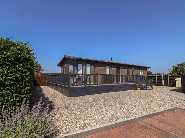 A house with decking and gravel at Hazelwood 3 Pinewood Retreat in Rousdon near Lyme Regis