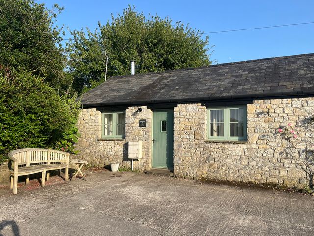 A cottage with a door and windows near a pathway at Warbler Cottage near Cowbridge