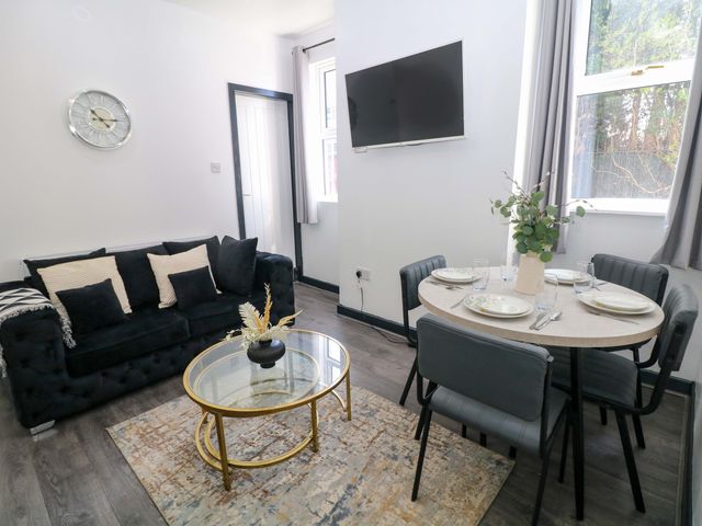 A living room with a sofa, dining area and television at 22 Garfield Street, Stoke-on-Trent