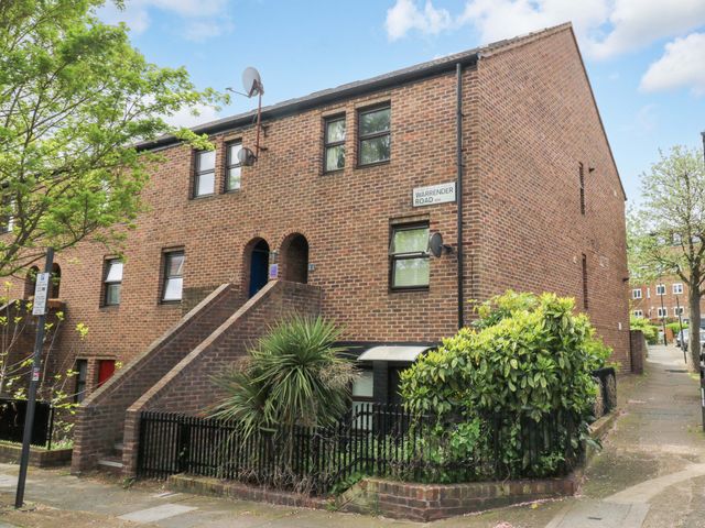 A brick building with windows and stairs at 22A Warrender Road Tufnell Park
