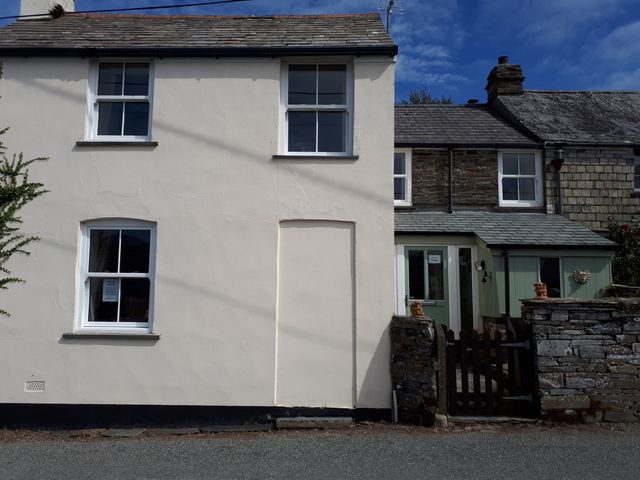 A house exterior with windows and door at Trelake Cottage 