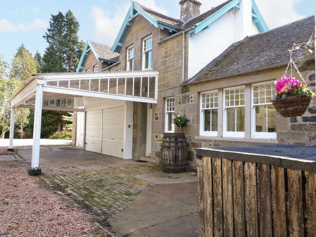 A house with a garage and barrel at West House in Stanley