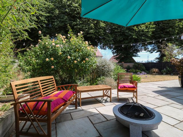 A garden with seating area and fire pit at The Annexe @ Shotley Cottage Shotley Gate