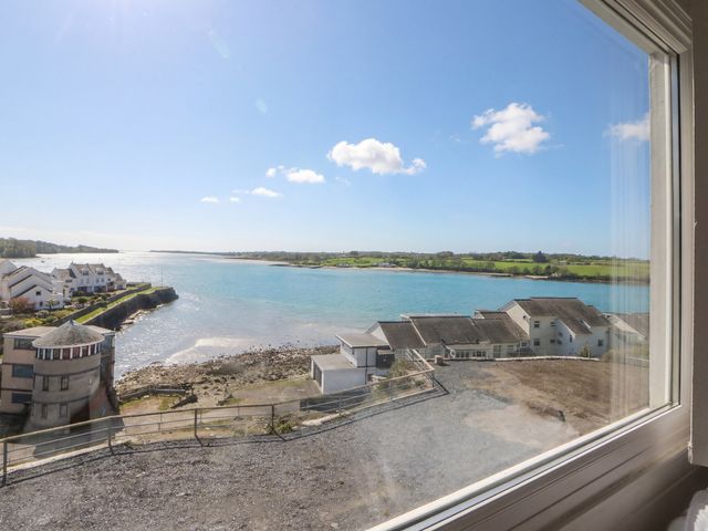 A view of water and houses from a window at Seaview in Y Felinheli