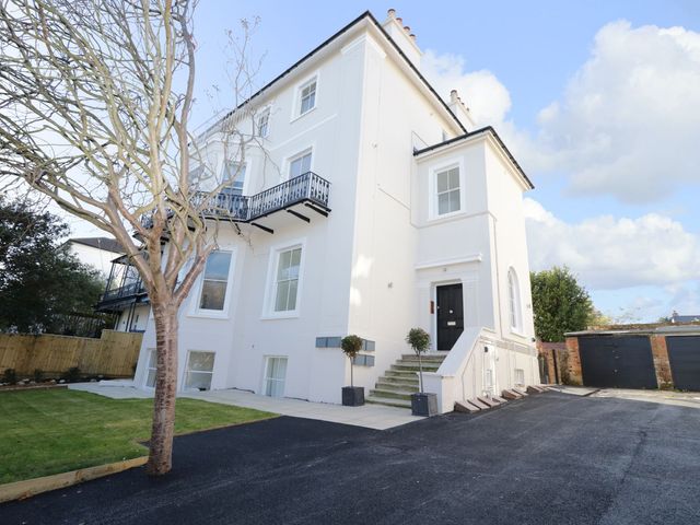 A building with a balcony and garden at Hamilton's Studio in Ryde
