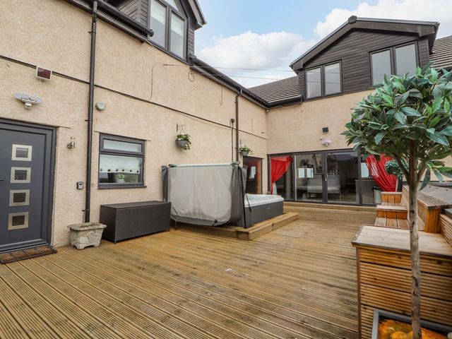An outdoor space with a hot tub and seating area at The Wendover in Abergele