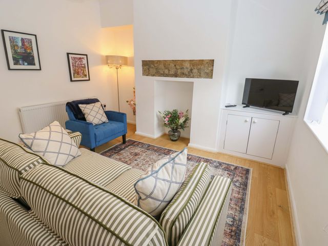 A living room with a sofa and armchair at Saltaire House in Saltaire