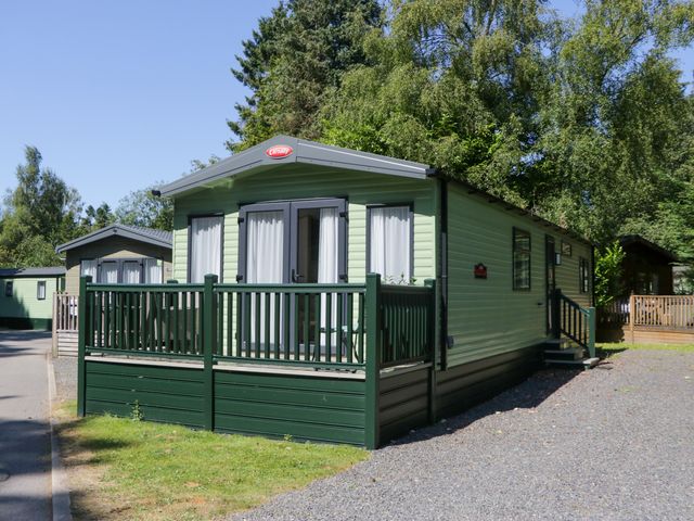 A green caravan with a deck at 51 Calgarth Park in Troutbeck