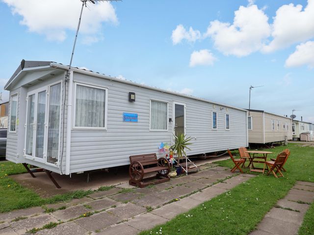 A mobile home with outdoor seating at 15 Cherry Tree walk in Rhyl