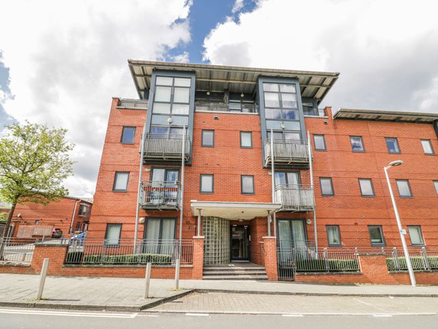 A residential building with balconies and trees nearby at Apartment 10 in Birmingham