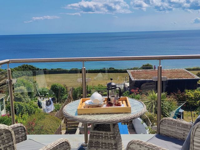 A balcony with a table and a tray at Ty Bryn Marazion