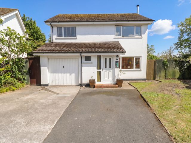 A house with a garage and driveway at 1 Rosemount Garden Villas Tenby