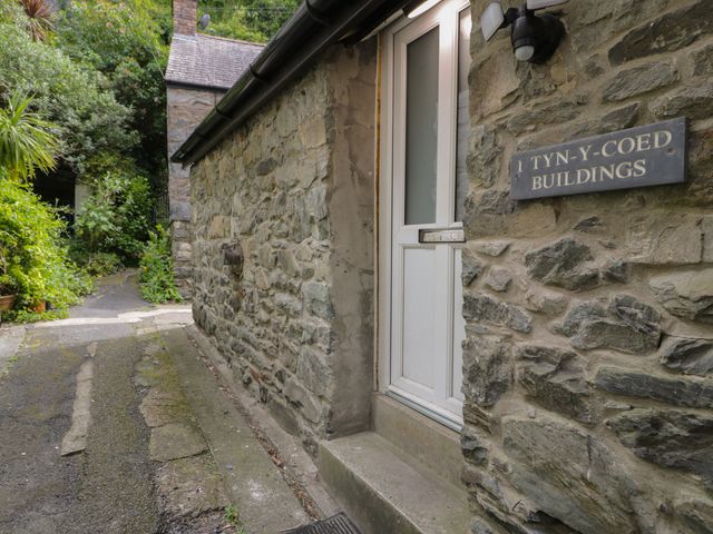 A building entrance with a stone wall and pathway at Llety Cllyd Barmouth