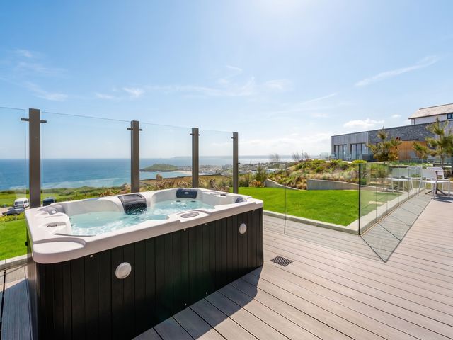 An outdoor hot tub with ocean view at Hidden 19- Coastal Hot Tub in St Ives
