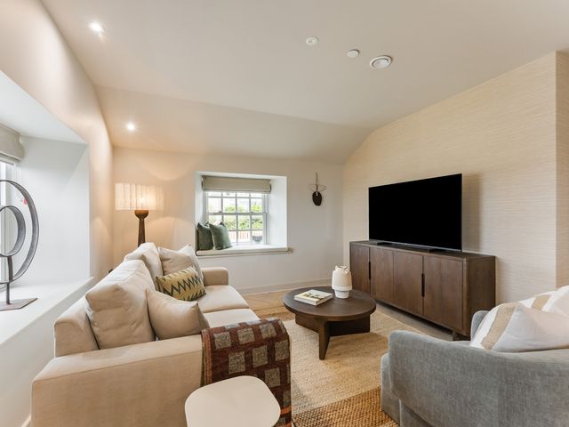 A living room with a sofa and television at tbc in St. Ives