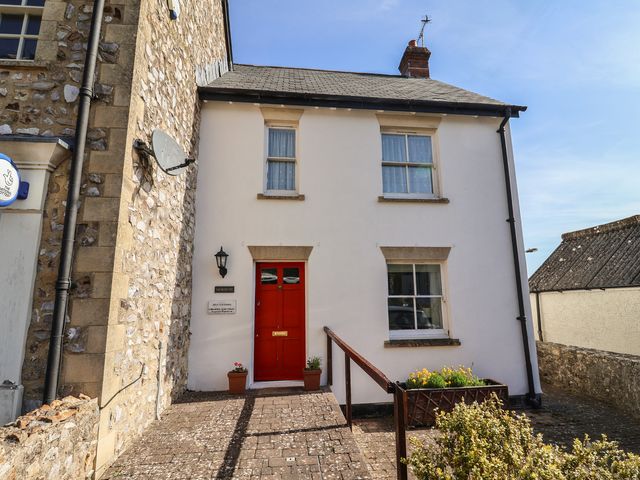 A house with a red door and windows at Morpeth in Combe St Nicholas