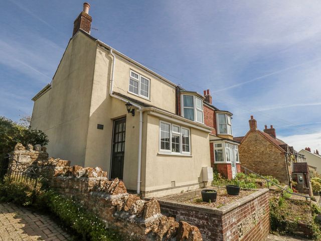 A house with a garden and stone wall at 12 West Street Weymouth