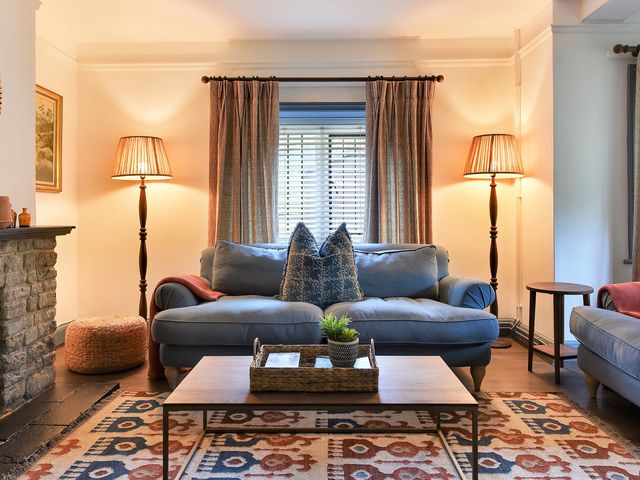 A living room with a sofa and coffee table at Home Farm Cottage in Peterborough