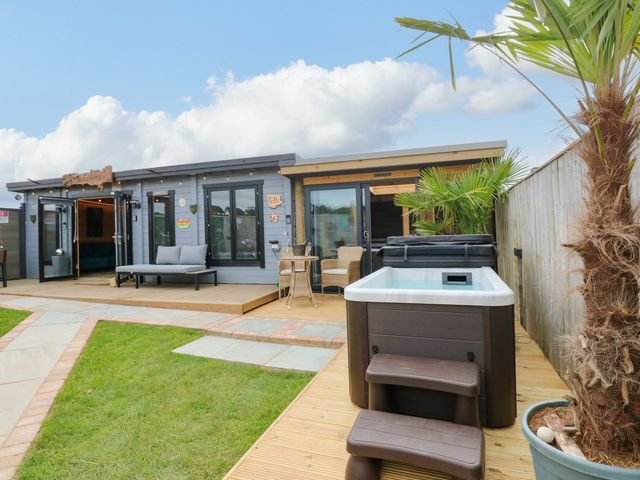 An outdoor area with a hot tub and seating at Black River Houghton Bank near Heighington