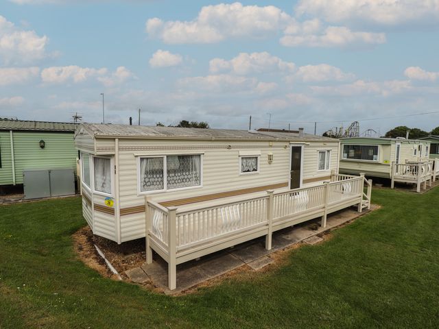A caravan with a porch in an outdoor area at Caravan 25 Ingoldmells