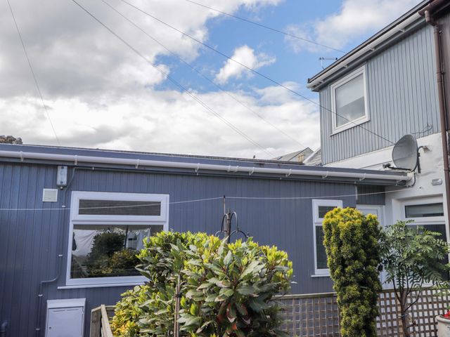 A house exterior with plants and a satellite dish at 4A Carny Street in Macduff