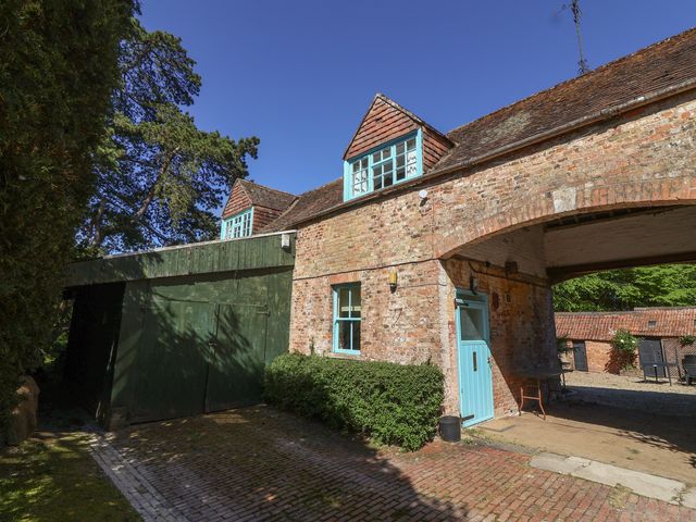 An exterior view of a building with a green door at The Old Stables in Gloucester