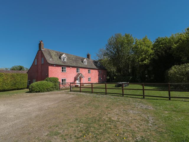 A house with a garden and fence at Walk Farmhouse in Gloucester